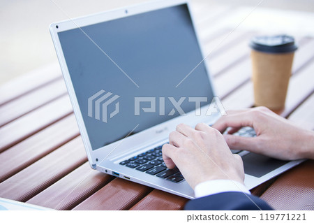 Business image: A young man operating a computer Business image: A young man operating a computer 119771221