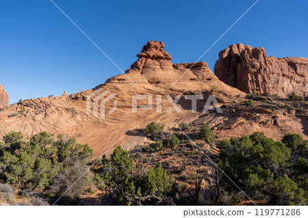 A stunning view of red rocks during golden hour in Arches National Park. 119771286