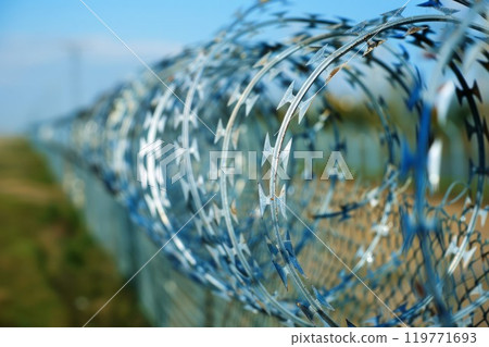 barbed wire steel wall against the immigations in europe. Neural network ai generated art 119771693