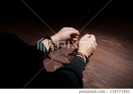 Man in handcuffs 119771993