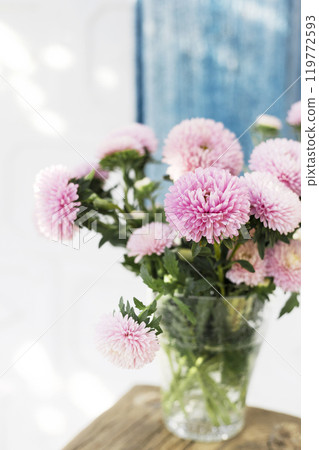 bouquet of asters on the table in the summer garden 119772593