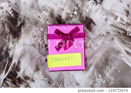 Top view of a beautiful gift box with a handwritten thank you note. 119772674