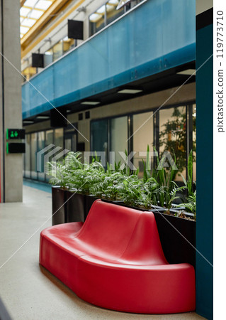 Vertical shot of lounge area in business center featuring biophilic design elements and cozy seating in vibrant red color inside two storey office building, copy space Vertical shot of lounge area in business center featuring biophilic design elements and cozy seating in vibrant red color inside two storey office building, copy space 119773710