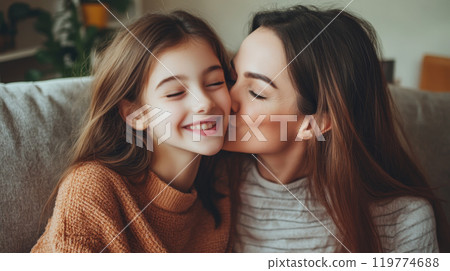 Mother and Daughter Sharing a Loving Moment on the Couch 119774688