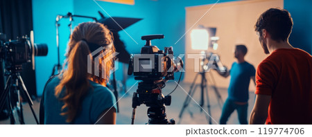 Videographer Filming in Studio with Professional Camera 119774706