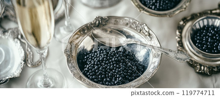 Black Caviar and Champagne on Elegant Table Setting 119774711