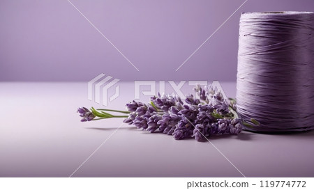 Lavender Flowers and a Spool of Lavender Thread on a Soft Pastel Background Creating a Serene Lavender Flowers and a Spool of Lavender Thread on a Soft Pastel Background Creating a Serene 119774772