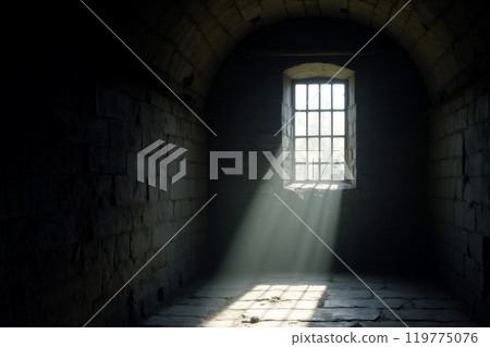 Solitary light in an abandoned prison cell 119775076