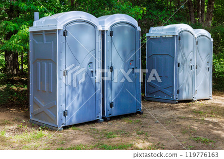 Long row portable bio of chemical toilets cabins in park center at city Long row portable bio of chemical toilets cabins in park center at city 119776163