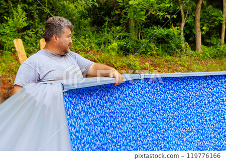 Construction ground swimming pool will be assembled in backyard of house 119776166