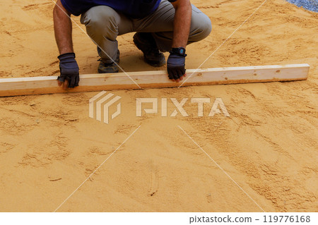 Leveling sand base is required before installation of newly installed swimming pool in backyard Leveling sand base is required before installation of newly installed swimming pool in backyard 119776168