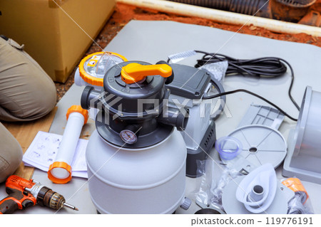 During maintenance, sand filter system tanks are assembled, as well swimming pool cleaning equipment 119776191