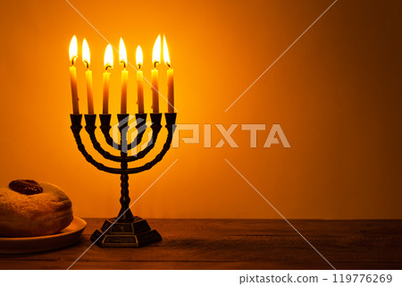 Hanukkah Menorah with burning candles and sufganiyah donuts Hanukkah Menorah with burning candles and sufganiyah donuts 119776269