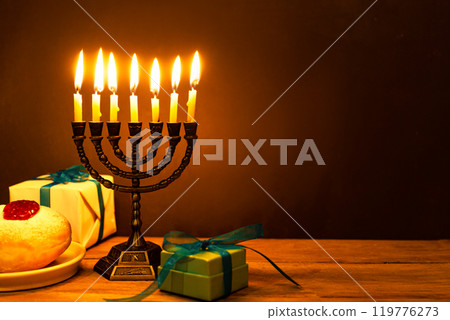 Hanukkah Menorah with burning candles and sufganiyah donuts Hanukkah Menorah with burning candles and sufganiyah donuts 119776273
