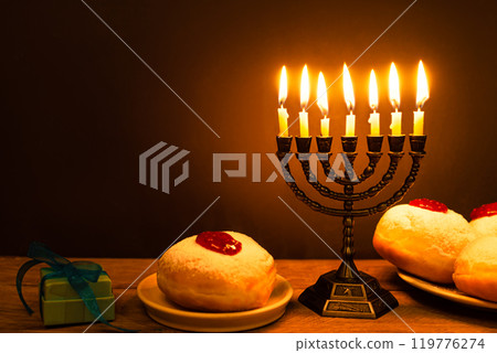 Hanukkah symbols: Menorah candles and sufganiyah jelly donuts 119776274