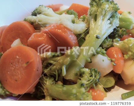 vegetarian dish with green broccoli and carrots. close up of boiled vegetables 119776359