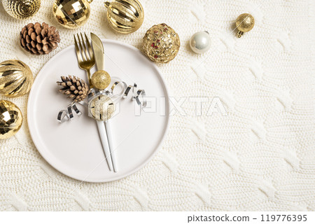 Christmas table setting on knitted background 119776395