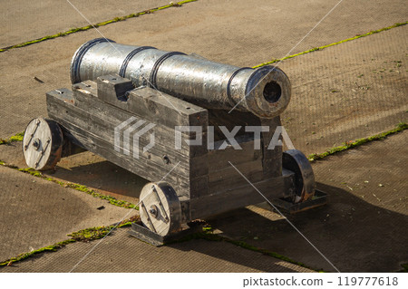 Antique iron cannon on wheels. Antique iron cannon on wheels. 119777618