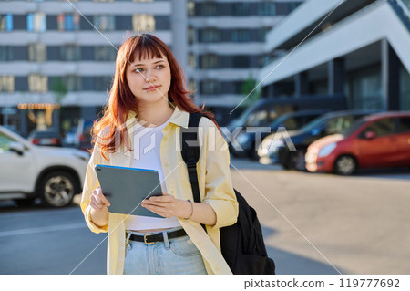 Young female college student with digital tablet, outdoors 119777692