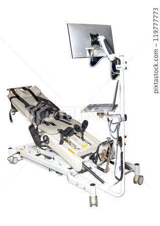 Medical examination table with a monitor and computer setup used for patient assessments in a clinical environment. Isolated on a white background. 119777773