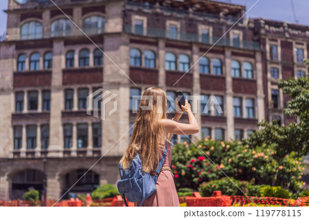 Female tourist in the central square of Mexico City, Zocalo. Cultural exploration, travel, and historic architecture concept Female tourist in the central square of Mexico City, Zocalo. Cultural exploration, travel, and historic architecture concept 119778115
