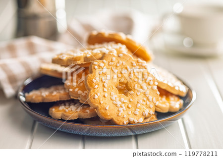 Sweet cookies in the shape of a flower. Tasty biscuits on plate on white table. 119778211