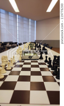 An empty hall with tables on which chess boards and timers are prepared. Concept of competition sport chess, leadership skills, self-development. 119778280