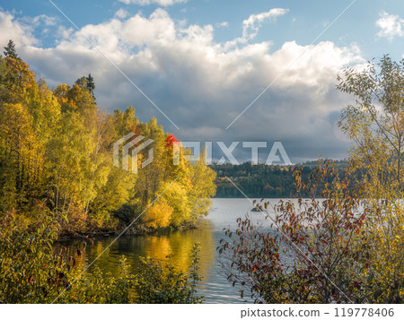 Scenic Autumn Landscape With Vibrant Colors by a Peaceful Lake Scenic Autumn Landscape With Vibrant Colors by a Peaceful Lake 119778406