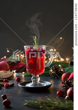 Christmas cranberry and apple mulled wine garnish rosemary and fir branches on black. Close up. Xmas drink. Christmas cranberry and apple mulled wine garnish rosemary and fir branches on black. Close up. Xmas drink. 119778640