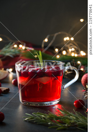 Christmas cranberry and apple mulled wine garnish rosemary and fir branches on black. Close up. Xmas drink. Christmas cranberry and apple mulled wine garnish rosemary and fir branches on black. Close up. Xmas drink. 119778641