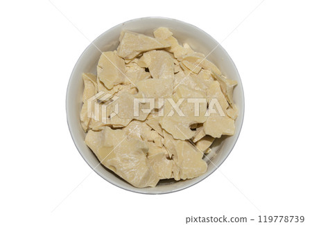 Cocoa butter background, top view, texture. Cocoa butter is one of the ingredients in making chocolate at home. Close-up of crushed cocoa butter, top view. 119778739