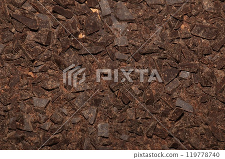 Grated cocoa background, top view, texture. Grated cocoa is one of the ingredients in making chocolate at home. Close-up of crushed cocoa, top view. 119778740