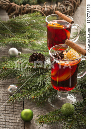 Christmas tradition drink. Hot Mulled wine with cinnamon and christmas tree on black slate dish. Close up, copy space. Christmas tradition drink. Hot Mulled wine with cinnamon and christmas tree on black slate dish. Close up, copy space. 119778766