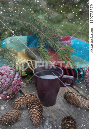 Season cup of hot tea on wooden table. Still life of cones and fir branches. Preparing for Christmas. Warming beverage. Season cup of hot tea on wooden table. Still life of cones and fir branches. Preparing for Christmas. Warming beverage. 119778779