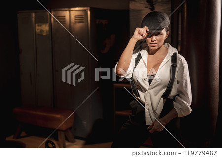 Caucasian woman in a men's suit in the style of Peaky Blinders. 119779487