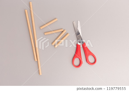 scissors cutting paper straw step in DIY project quick assembly creative process for making simplified children toy, 119779555