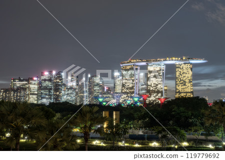 SINGAPORE, SINGAPORE - August 26, 2023: Panorama view of Skyline of Singapore Marina Bay at night with Marina Bay sands, Art Science museum and Flyer. 119779692