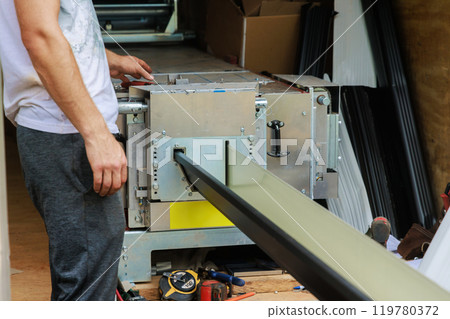 Bending thin metal rain gutters is performed with bending machine Bending thin metal rain gutters is performed with bending machine 119780372