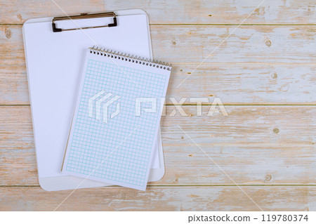 On modern office desk, notebook, are placed for use while working On modern office desk, notebook, are placed for use while working 119780374