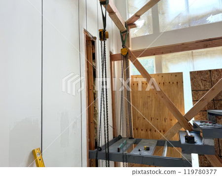 New building is undergoing installation of metal support stairs to second floor 119780377