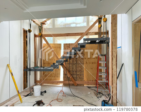 In new building, metal support stairs are being installed to reach second floor 119780378