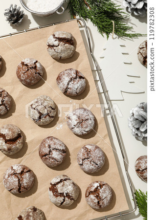 Appetizing crinkle cookies, on parchment, on a dark background. Appetizing crinkle cookies, on parchment, on a dark background. 119782308