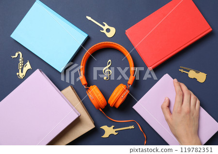 Books with modern headphones, on a blue background. Books with modern headphones, on a blue background. 119782351