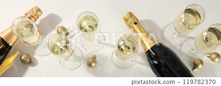A bottle of champagne with glasses and Christmas balls 119782370