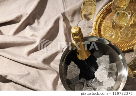 A bottle of champagne in a bucket with ice 119782375