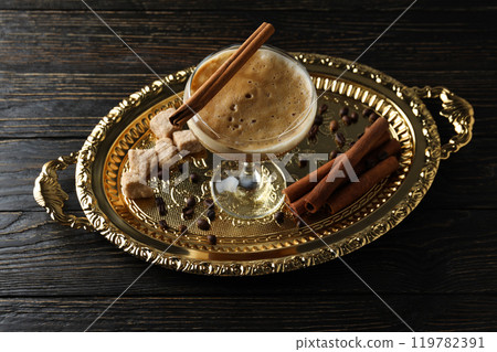 Martini espresso cocktail, cinnamon and sugar on golden tray on wooden background 119782391