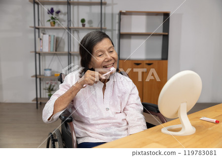 Elderly asian woman brushing teeth with brush with dental floss. 119783081