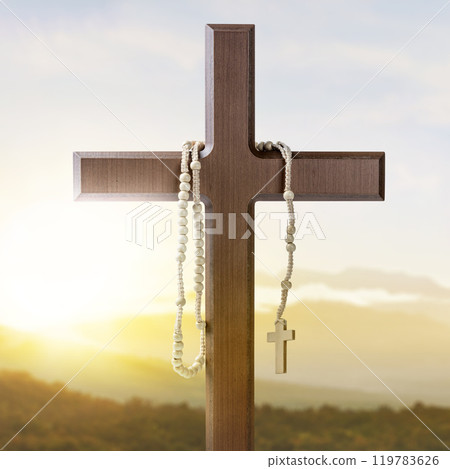 Religion christianity cross and rosary beads with sunlight background. Symbol of faith and worship in God 119783626