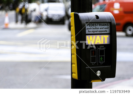 Crosswalk button for pedestrian with light warning on a defocused background, London, UK 119783949