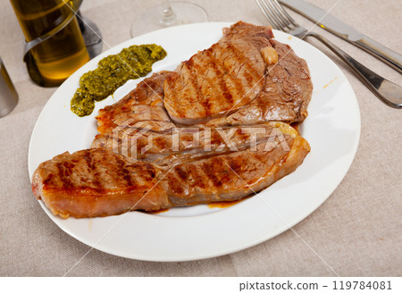 Prepared steak of beef with pesto sauce at plate 119784081